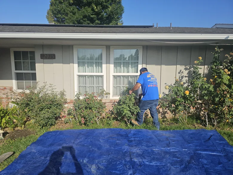 Crew working along front of a home