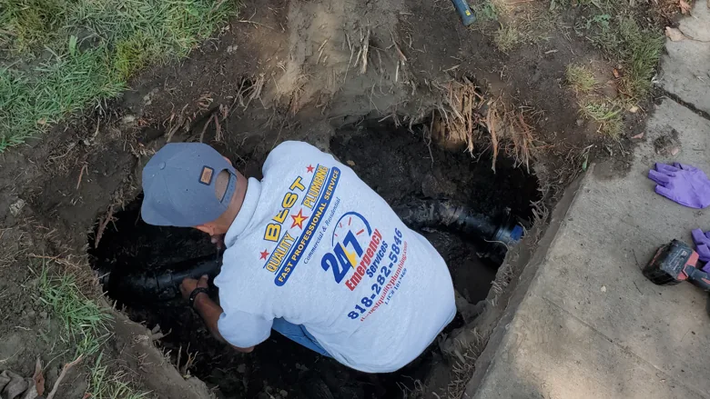 Technician working inside outdoor excavation