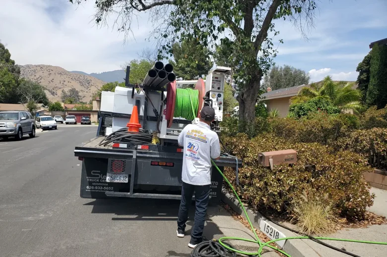 Technician operating truck-mounted hose-reel equipment