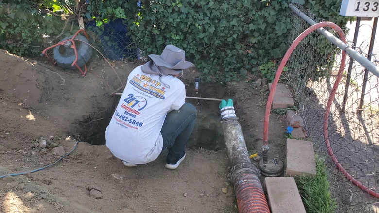 Technician working on exposed underground line