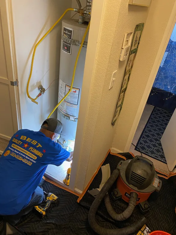 Technician working in a narrow utility closet