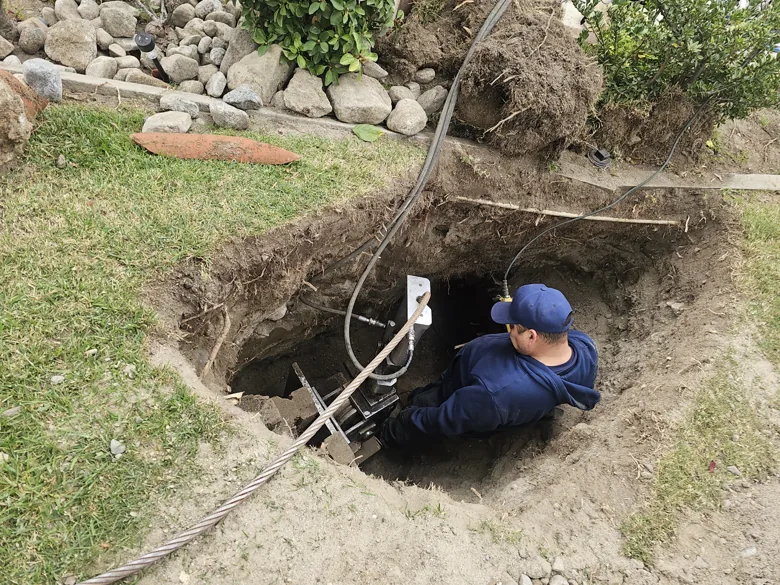 Technician in deep excavation with access ladder