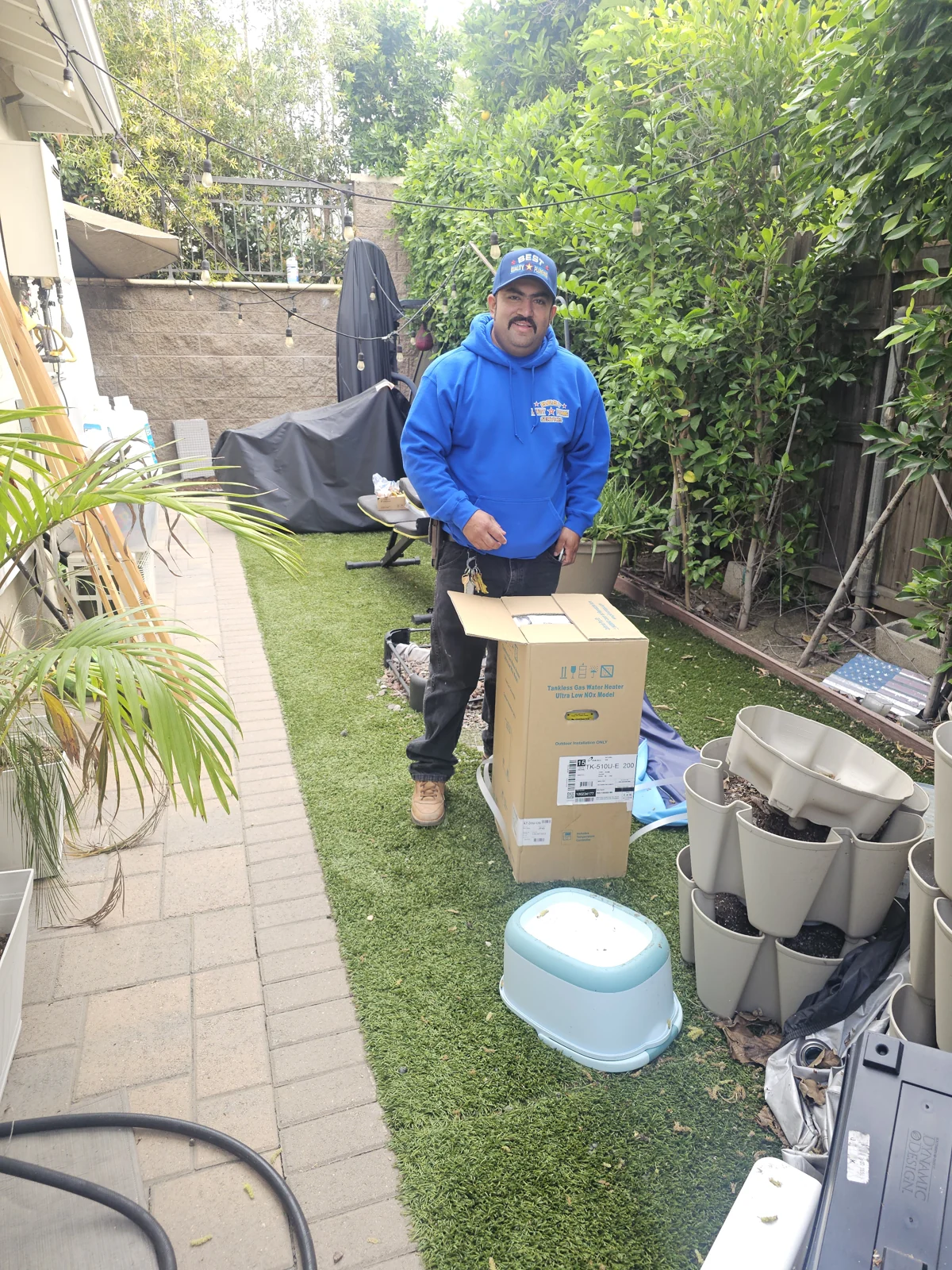 Plumber beside a removed toilet and installation supplies